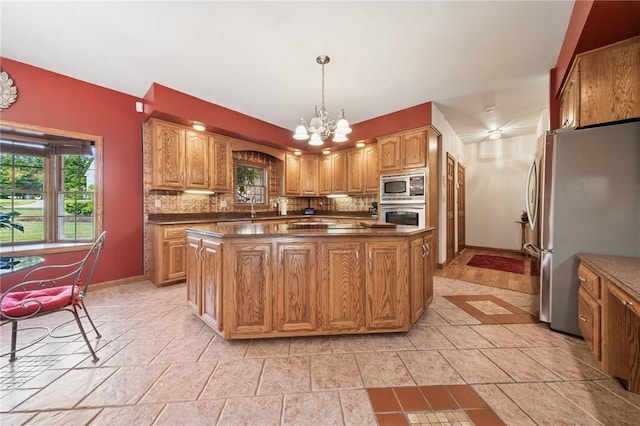 101 Blackthorn Dr, Penn Twp But, PA 16002 - kitchen featuring stainless steel appliances, decorative backsplash, a chandelier, a kitchen island, and dark countertops