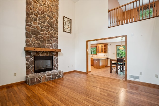 29 Cherry Tree Ln, Mercer Boro Mer, PA 16137 - living room with hardwood / wood-style flooring, a stone fireplace, and a high ceiling