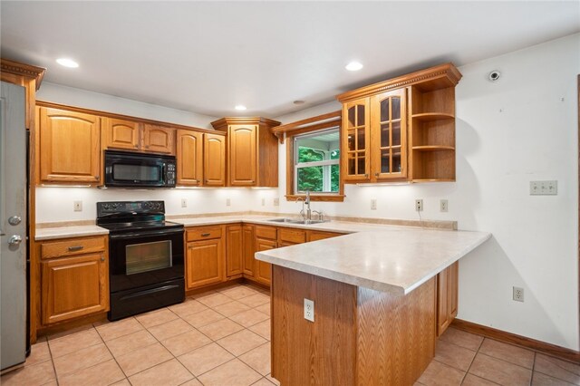 29 Cherry Tree Ln, Mercer Boro Mer, PA 16137 - kitchen with black appliances, a peninsula, glass insert cabinets, light tile patterned floors, and light countertops