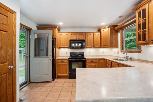 29 Cherry Tree Ln, Mercer Boro Mer, PA 16137 - kitchen with black appliances, glass insert cabinets, light countertops, light tile patterned floors, and a peninsula