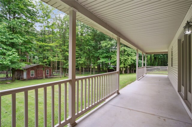 29 Cherry Tree Ln, Mercer Boro Mer, PA 16137 - covered porch with a yard, an outdoor structure, and view of wooded area