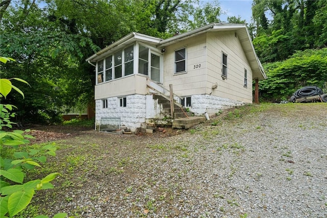 320 Cline St, E Pittsburgh, PA 15112 - view of side of home featuring a sunroom and gravel driveway