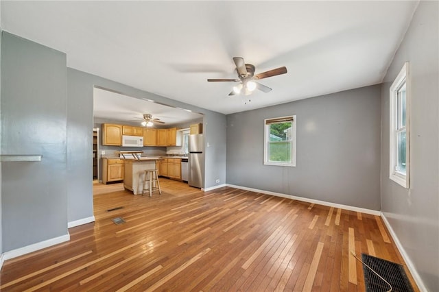 320 Cline St, E Pittsburgh, PA 15112 - unfurnished living room featuring light wood-style flooring and a ceiling fan