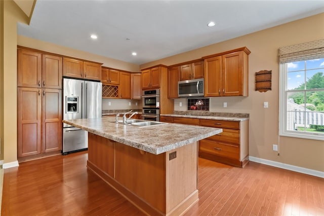 121 Anglers Way, Peters Twp, PA 15317 - kitchen featuring appliances with stainless steel finishes, light countertops, light wood-style floors, brown cabinets, and recessed lighting