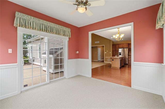 121 Anglers Way, Peters Twp, PA 15317 - spare room featuring light carpet, a wainscoted wall, a chandelier, and a ceiling fan