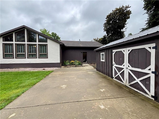 2105 Pulaski Rd, Neshannock Twp, PA 16105 - view of front of house with a storage unit, a patio, and a front lawn