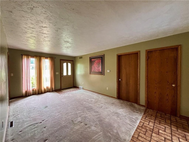 2105 Pulaski Rd, Neshannock Twp, PA 16105 - foyer entrance featuring brick floors and a textured ceiling