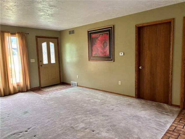 2105 Pulaski Rd, Neshannock Twp, PA 16105 - carpeted entryway with a textured ceiling and brick patterned flooring