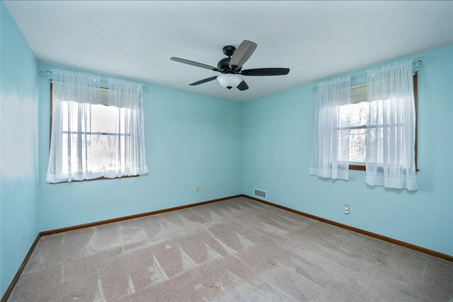 10496 Roseway Blvd, North Huntingdon, PA 15642 - carpeted empty room featuring plenty of natural light and a ceiling fan