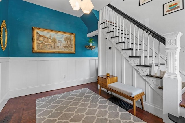1037 Chislett St, Morningside, PA 15206 - staircase featuring wood finished floors, a skylight, a wainscoted wall, a decorative wall, and vaulted ceiling