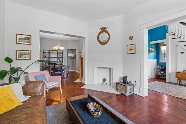 1037 Chislett St, Morningside, PA 15206 - living area with wood finished floors, a chandelier, and stairs