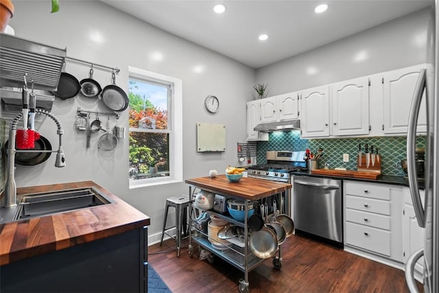 1037 Chislett St, Morningside, PA 15206 - kitchen featuring butcher block counters, stainless steel appliances, backsplash, under cabinet range hood, and white cabinets