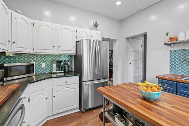 1037 Chislett St, Morningside, PA 15206 - kitchen with appliances with stainless steel finishes, butcher block countertops, decorative backsplash, white cabinets, and recessed lighting