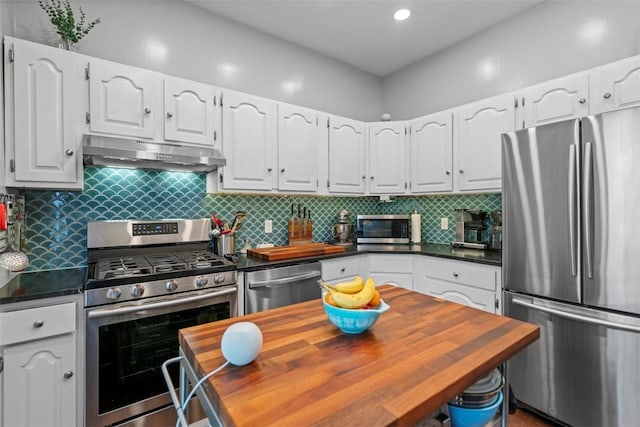 1037 Chislett St, Morningside, PA 15206 - kitchen featuring stainless steel appliances, under cabinet range hood, white cabinets, decorative backsplash, and recessed lighting