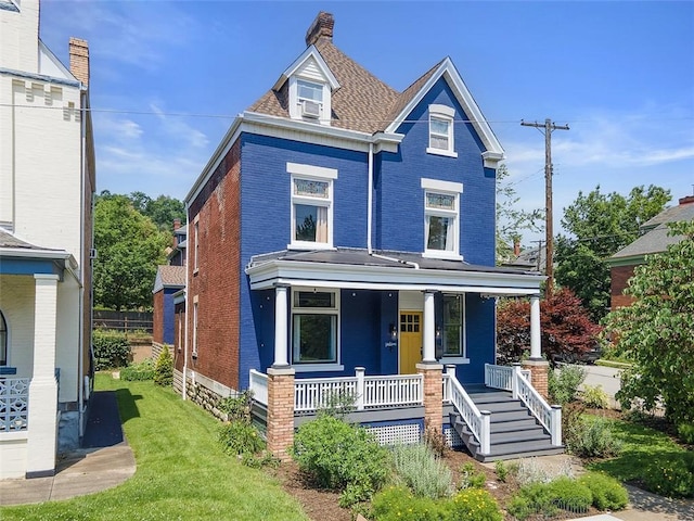1037 Chislett St, Morningside, PA 15206 - victorian house with covered porch, brick siding, a chimney, and a front yard
