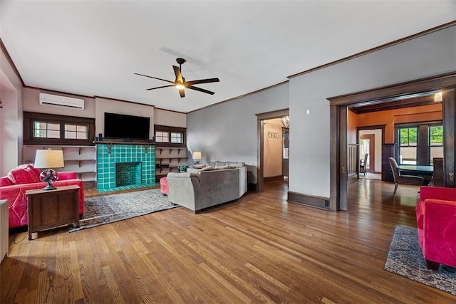 81 Dinsmore Ave, Crafton, PA 15205 - living room featuring a wall mounted air conditioner, wood finished floors, ceiling fan, a tile fireplace, and crown molding