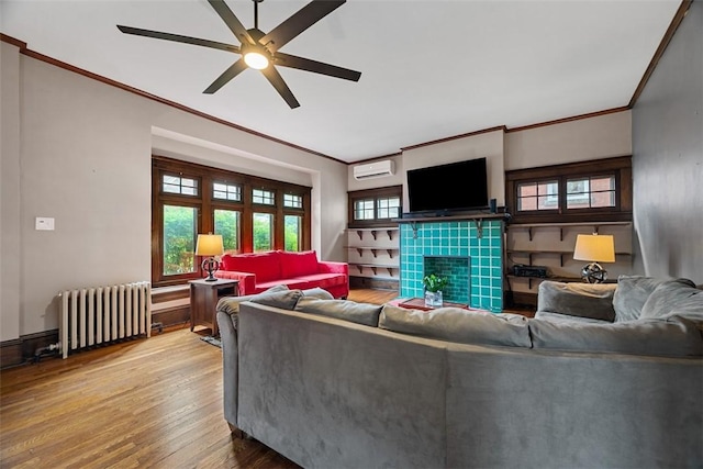 81 Dinsmore Ave, Crafton, PA 15205 - living room with radiator heating unit, crown molding, a wall mounted AC, wood finished floors, and ceiling fan