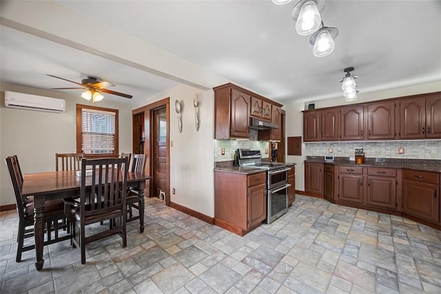 81 Dinsmore Ave, Crafton, PA 15205 - kitchen featuring a wall mounted air conditioner, range with two ovens, decorative backsplash, dark countertops, and under cabinet range hood