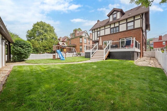 81 Dinsmore Ave, Crafton, PA 15205 - rear view of house with a fenced backyard, a wooden deck, a playground, brick siding, and stairway