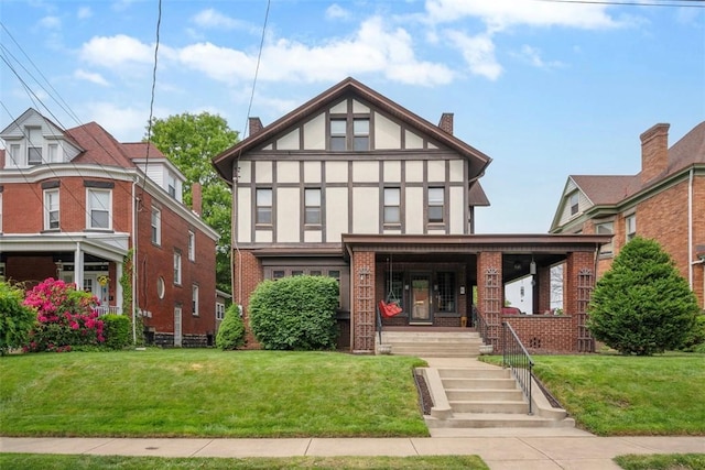 81 Dinsmore Ave, Crafton, PA 15205 - english style home featuring a porch, brick siding, a front lawn, stucco siding, and a chimney