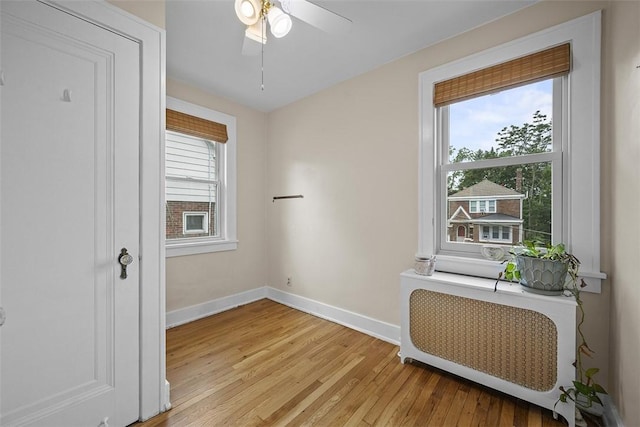 4035 Ludwick St, Squirrel Hill, PA 15217 - unfurnished room featuring plenty of natural light, light wood-style floors, ceiling fan, and radiator heating unit