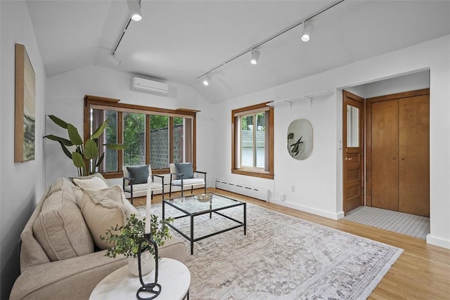 4035 Ludwick St, Squirrel Hill, PA 15217 - living room with track lighting, a wall mounted air conditioner, a baseboard radiator, vaulted ceiling, and wood finished floors