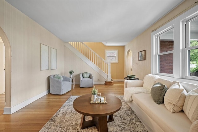 4035 Ludwick St, Squirrel Hill, PA 15217 - living room with arched walkways, stairs, and light wood-type flooring
