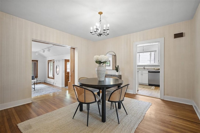4035 Ludwick St, Squirrel Hill, PA 15217 - dining space with a chandelier, healthy amount of natural light, light wood-style floors, and baseboard heating