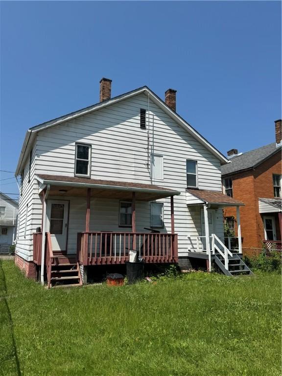 200 Jarvis St, Aliquippa, PA 15001 - back of house featuring a lawn, a chimney, and covered porch