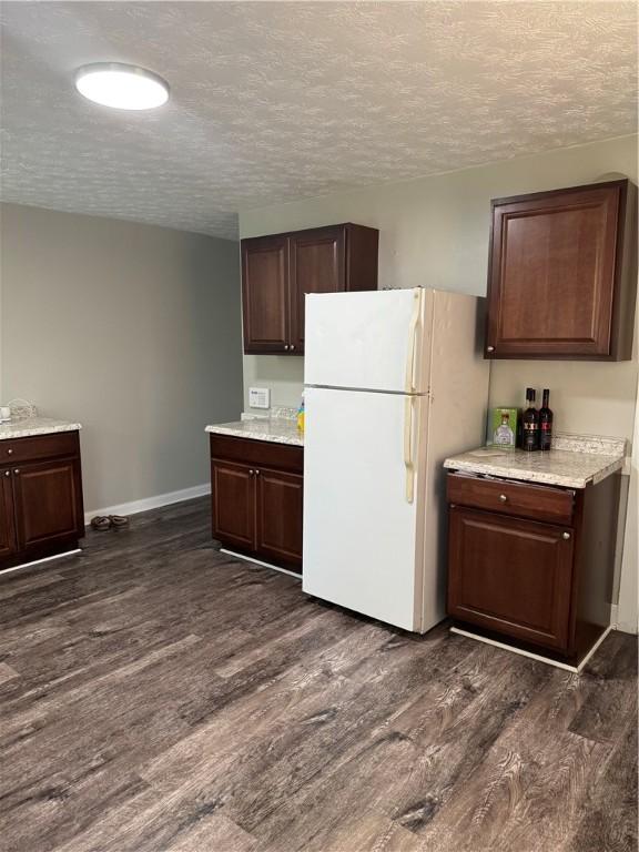 200 Jarvis St, Aliquippa, PA 15001 - kitchen featuring freestanding refrigerator, dark wood finished floors, a textured ceiling, and dark brown cabinets