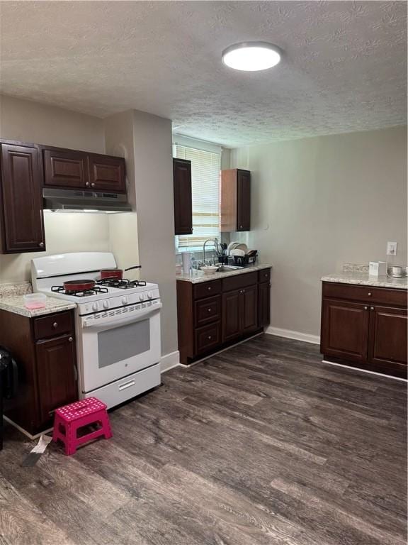 200 Jarvis St, Aliquippa, PA 15001 - kitchen with gas range gas stove, dark wood finished floors, a textured ceiling, under cabinet range hood, and light countertops