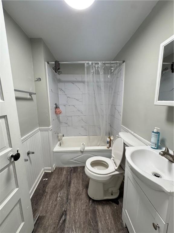 200 Jarvis St, Aliquippa, PA 15001 - full bathroom featuring vanity, shower / tub combo with curtain, wood finished floors, and a wainscoted wall