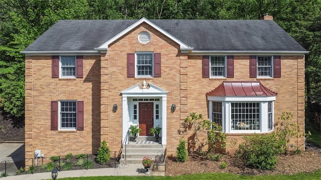 609 Twin Pine Rd, Fox Chapel, PA 15215 - view of front of house with a chimney, brick siding, and a standing seam roof
