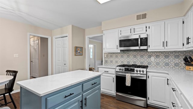 609 Twin Pine Rd, Fox Chapel, PA 15215 - kitchen with stainless steel appliances, white cabinetry, and dark wood finished floors