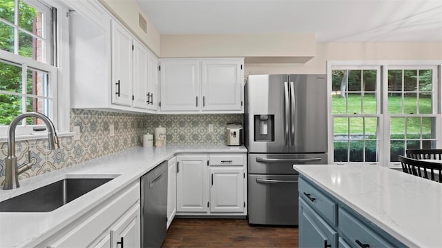 609 Twin Pine Rd, Fox Chapel, PA 15215 - kitchen with appliances with stainless steel finishes, white cabinetry, backsplash, dark wood finished floors, and light stone countertops