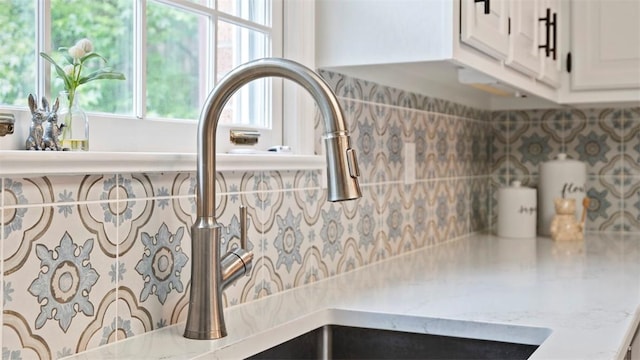 609 Twin Pine Rd, Fox Chapel, PA 15215 - kitchen view of decorative backsplash, light stone counters, and white cabinetry