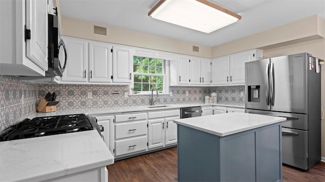 609 Twin Pine Rd, Fox Chapel, PA 15215 - kitchen featuring appliances with stainless steel finishes, a center island, dark wood finished floors, and white cabinets