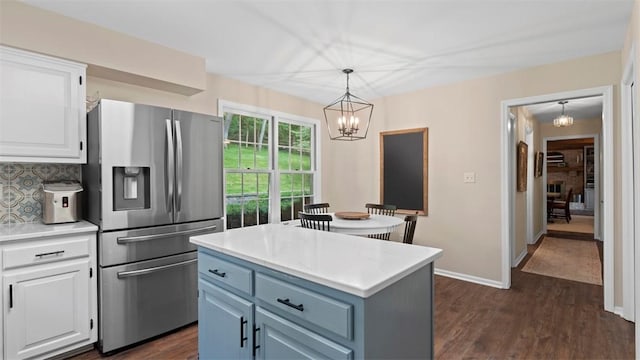 609 Twin Pine Rd, Fox Chapel, PA 15215 - kitchen with stainless steel fridge, a chandelier, white cabinets, light countertops, and dark wood finished floors