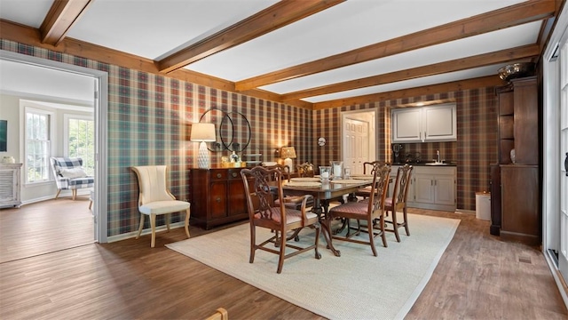 609 Twin Pine Rd, Fox Chapel, PA 15215 - dining area with wallpapered walls, beam ceiling, and light wood-type flooring