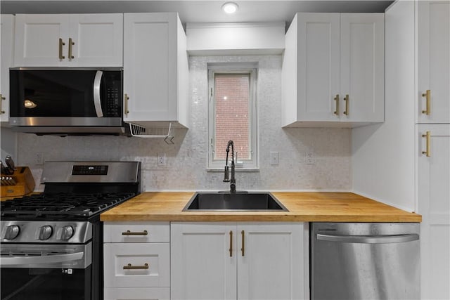 1028 Roseanne Ave, Banksville/Westwood, PA 15216 - kitchen with appliances with stainless steel finishes, butcher block counters, and decorative backsplash