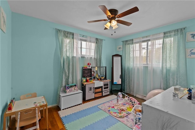 1028 Roseanne Ave, Banksville/Westwood, PA 15216 - playroom with a ceiling fan, wood finished floors, and a baseboard radiator