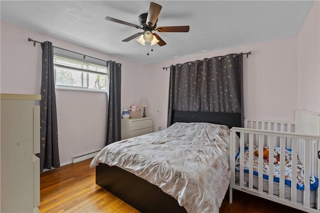 1028 Roseanne Ave, Banksville/Westwood, PA 15216 - bedroom featuring baseboard heating, wood finished floors, and a ceiling fan