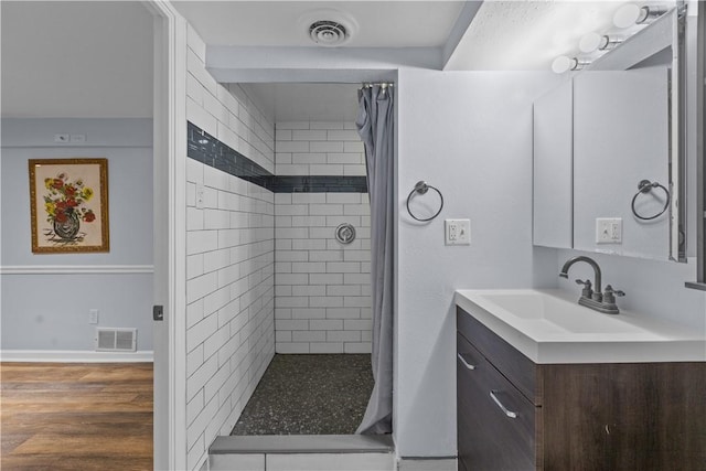 1028 Roseanne Ave, Banksville/Westwood, PA 15216 - bathroom featuring vanity, tiled shower, and wood finished floors
