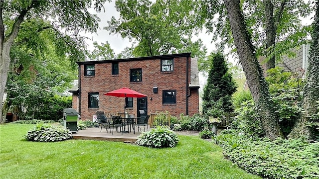 217 Monroe Dr, Ross Twp, PA 15229 - rear view of property featuring a lawn, brick siding, a deck, and outdoor dining area