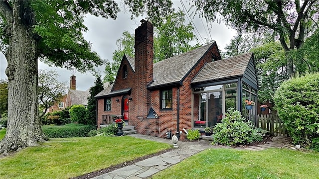 217 Monroe Dr, Ross Twp, PA 15229 - tudor home featuring a chimney, brick siding, a high end roof, and a front yard