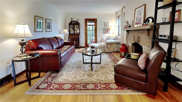 217 Monroe Dr, Ross Twp, PA 15229 - living room with wood finished floors and a stone fireplace