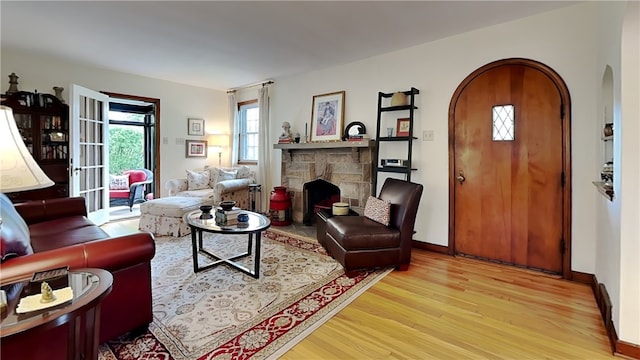 217 Monroe Dr, Ross Twp, PA 15229 - living area featuring arched walkways, wood finished floors, and a fireplace