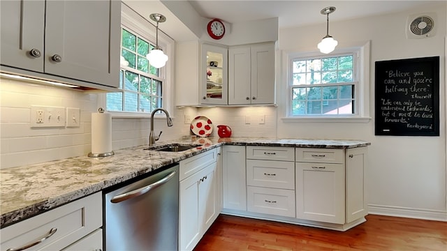 217 Monroe Dr, Ross Twp, PA 15229 - kitchen featuring stainless steel dishwasher, plenty of natural light, and light stone counters