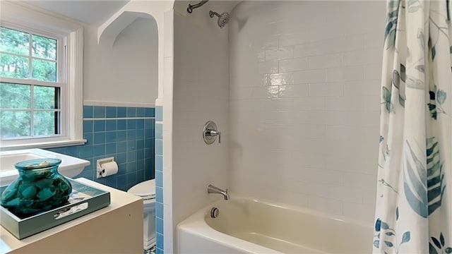 217 Monroe Dr, Ross Twp, PA 15229 - bathroom with shower / bath combination with curtain, vanity, tile walls, and a wainscoted wall