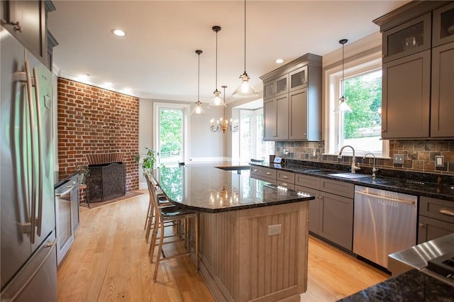 255 Camp Run Rd, Lancaster Twp, PA 16037 - kitchen with stainless steel appliances, light wood-style flooring, dark stone counters, backsplash, and recessed lighting